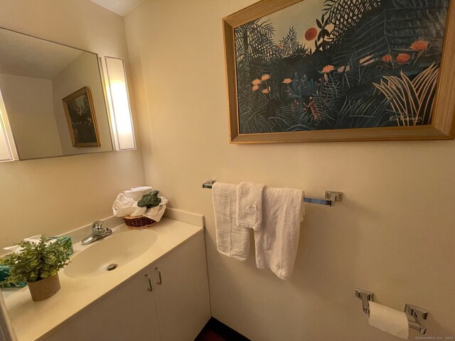 bathroom featuring a textured ceiling and vanity