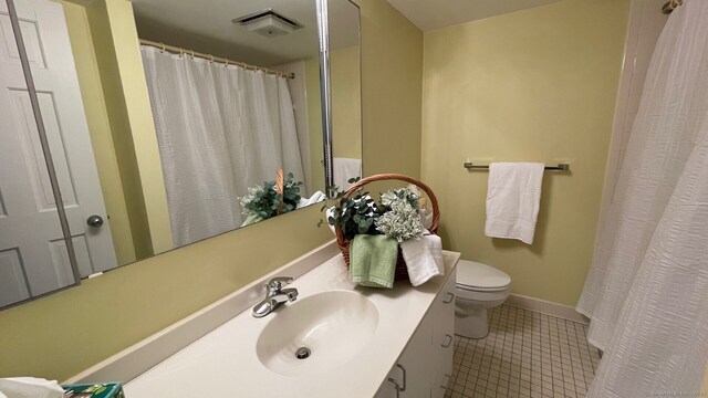 bathroom with vanity, tile patterned flooring, and toilet