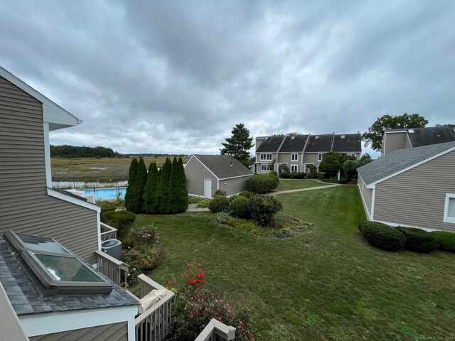 view of yard featuring a water view and a jacuzzi