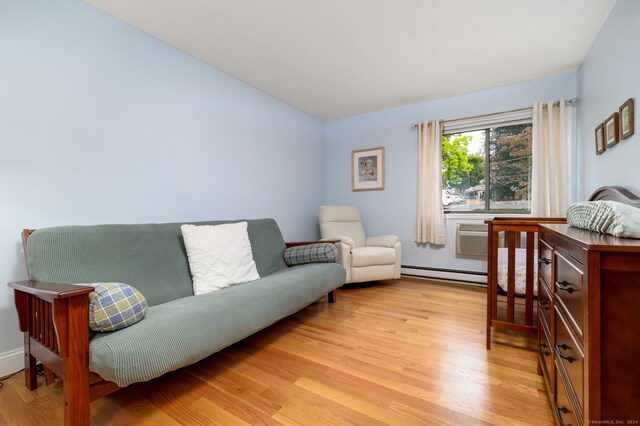 living room featuring light hardwood / wood-style flooring and a baseboard heating unit