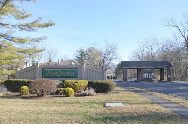 community / neighborhood sign with a lawn