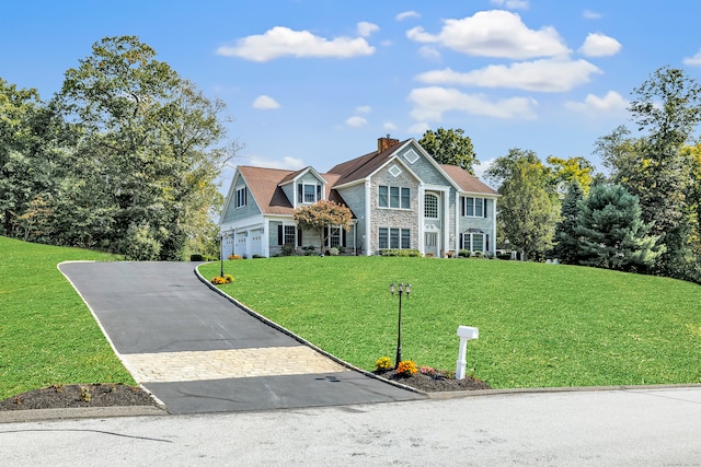 view of front of home with a garage and a front yard