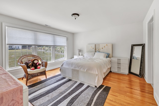 bedroom featuring hardwood / wood-style floors and multiple windows