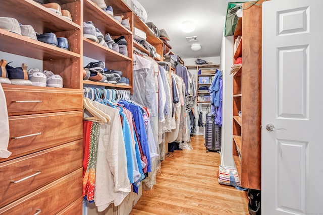 walk in closet featuring light hardwood / wood-style flooring