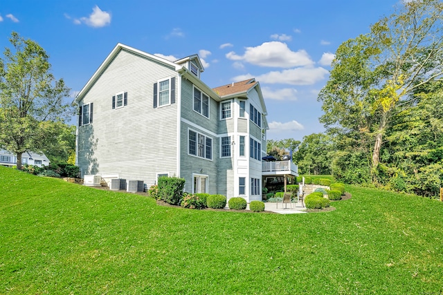 view of home's exterior featuring a lawn and a patio