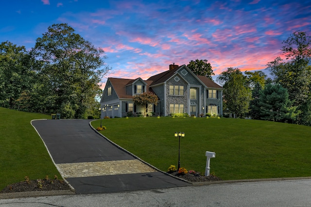 view of front facade with a lawn and a garage