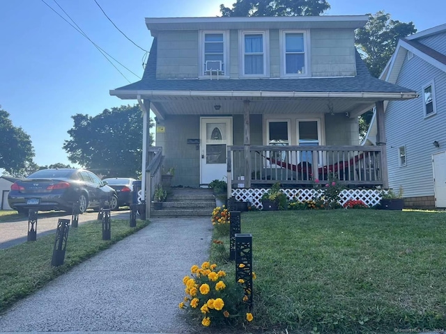 14 Bayview Pl, West Haven, CT 06516 - bungalow-style home with covered porch, roof with shingles, and a front yard