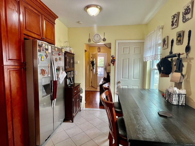 kitchen with light hardwood / wood-style floors and stainless steel fridge with ice dispenser