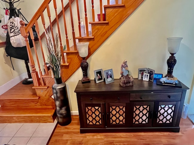 stairway with hardwood / wood-style flooring