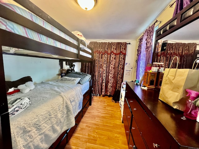 bedroom featuring light hardwood / wood-style flooring and crown molding