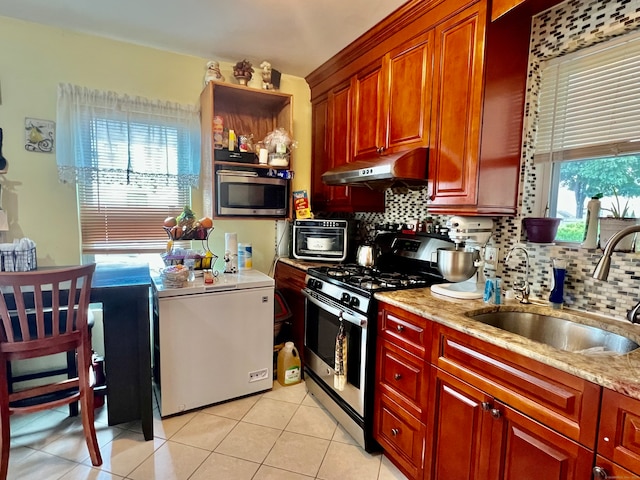 kitchen featuring light tile patterned floors, stainless steel appliances, sink, and tasteful backsplash