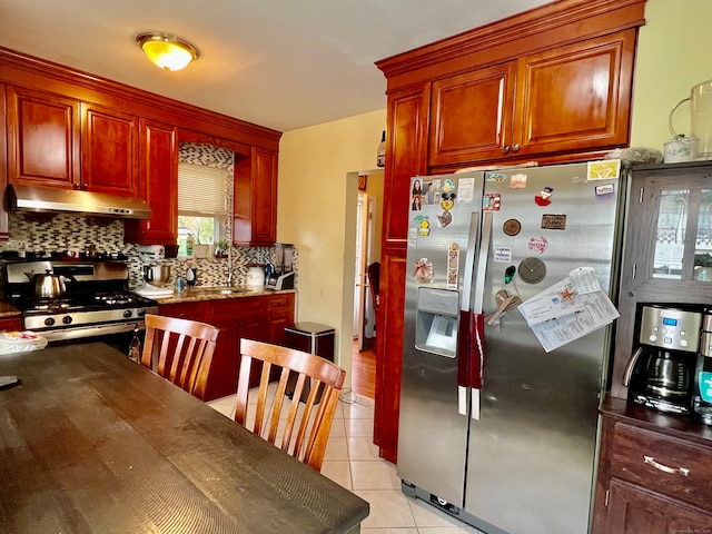 kitchen featuring sink, appliances with stainless steel finishes, backsplash, and light tile patterned floors