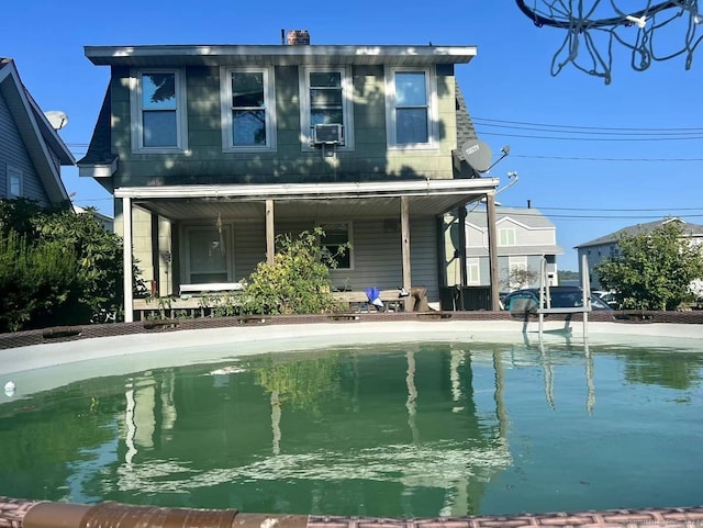 rear view of house featuring cooling unit