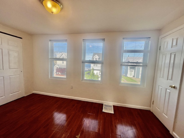 14 Bayview Pl, West Haven, CT 06516 - unfurnished bedroom featuring baseboards, dark wood-style flooring, and multiple windows