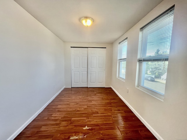 14 Bayview Pl, West Haven, CT 06516 - unfurnished bedroom with wood finished floors, baseboards, and a closet