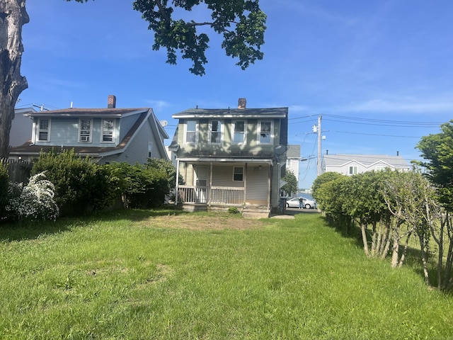 14 Bayview Pl, West Haven, CT 06516 - rear view of property featuring a porch, a lawn, and a chimney