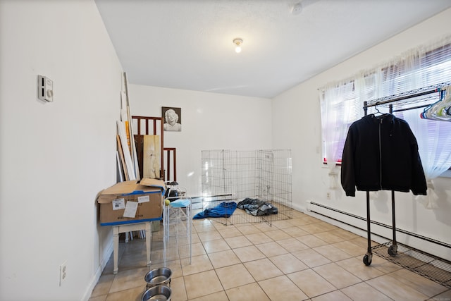 interior space featuring baseboard heating and light tile patterned flooring