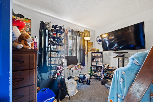 bedroom featuring carpet and a textured ceiling