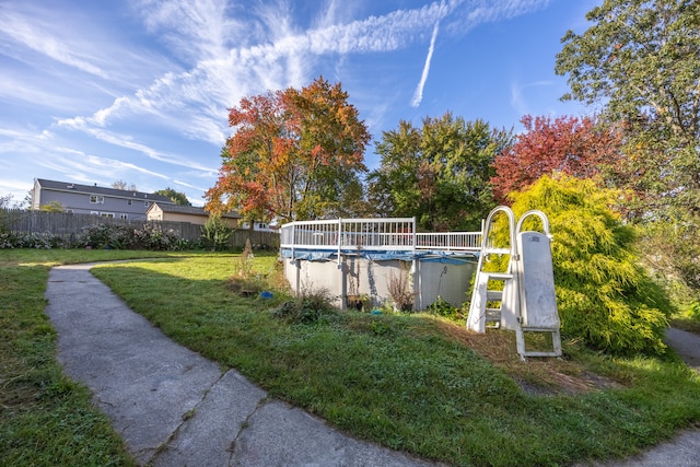 view of pool with a yard