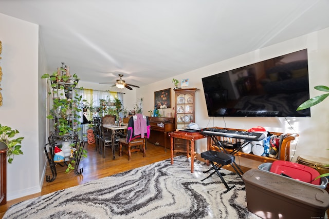 living room featuring hardwood / wood-style flooring and ceiling fan