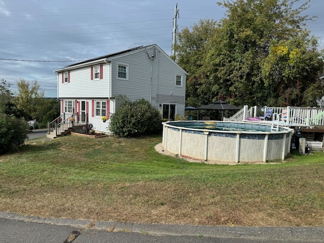 view of pool with a lawn