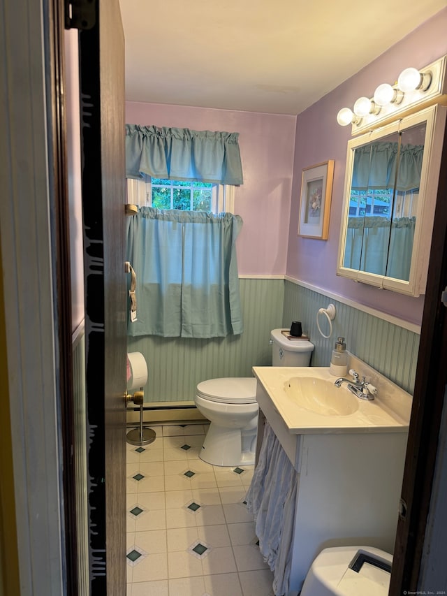 bathroom featuring vanity, tile patterned flooring, and toilet