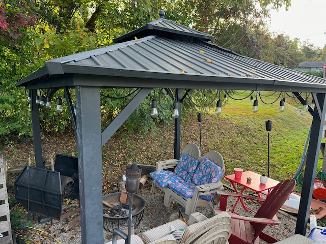 view of patio / terrace featuring a gazebo and a fire pit