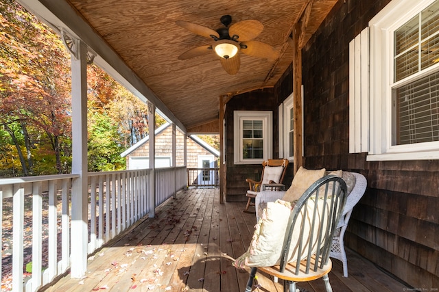 wooden terrace featuring a porch and ceiling fan