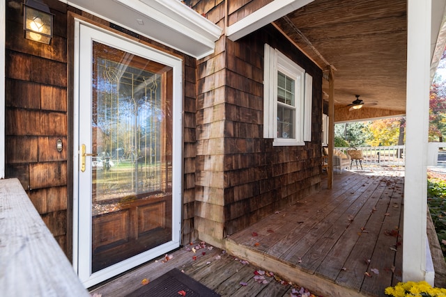 doorway to property featuring ceiling fan and a porch