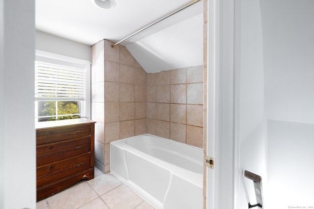 bathroom with bathtub / shower combination, tile patterned floors, and vaulted ceiling