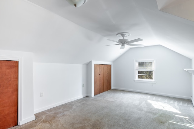 bonus room with light carpet, ceiling fan, and vaulted ceiling