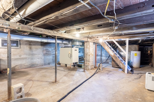 basement featuring electric water heater and heating unit