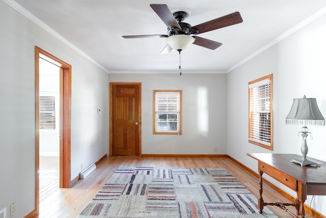 unfurnished office featuring ornamental molding, baseboard heating, light wood-type flooring, and ceiling fan