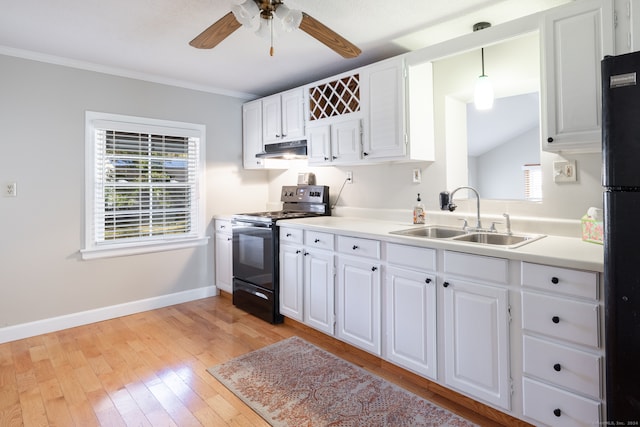 kitchen featuring black appliances, sink, hanging light fixtures, white cabinetry, and light hardwood / wood-style floors