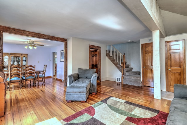 living room with wood-type flooring and ceiling fan