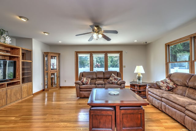 living room featuring light wood-type flooring and ceiling fan