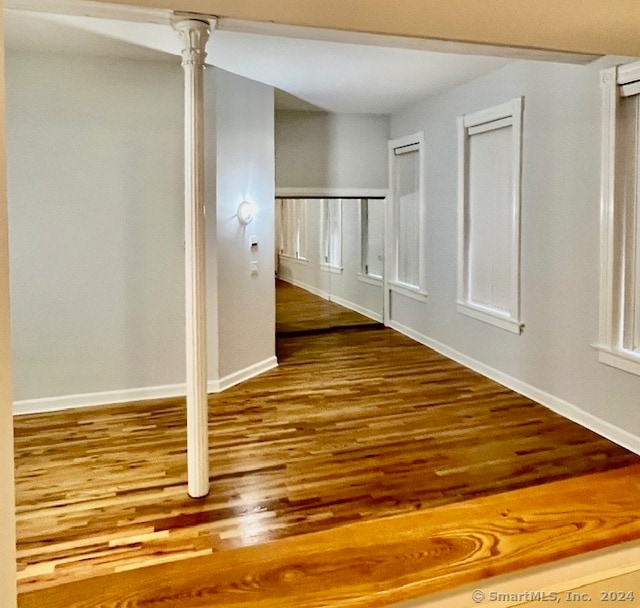 unfurnished room with hardwood / wood-style flooring