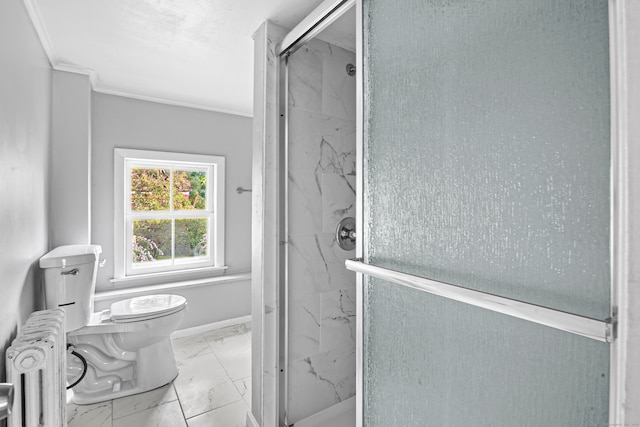 bathroom featuring radiator, crown molding, a shower with shower door, and toilet