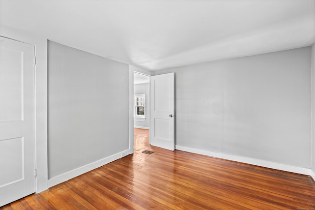 empty room with hardwood / wood-style floors