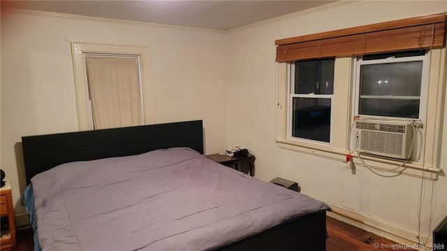 bedroom with dark wood-type flooring, cooling unit, and crown molding