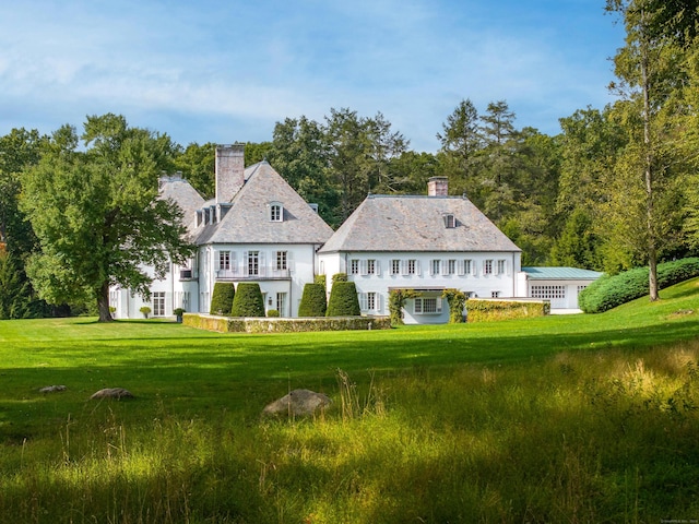 back of house with a lawn