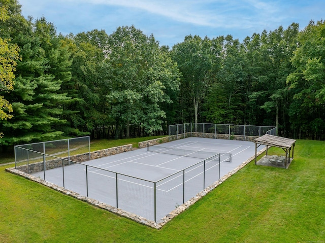 view of sport court with a yard