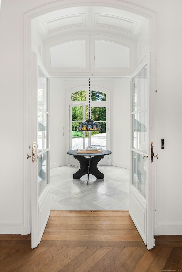 dining room with wood-type flooring and crown molding