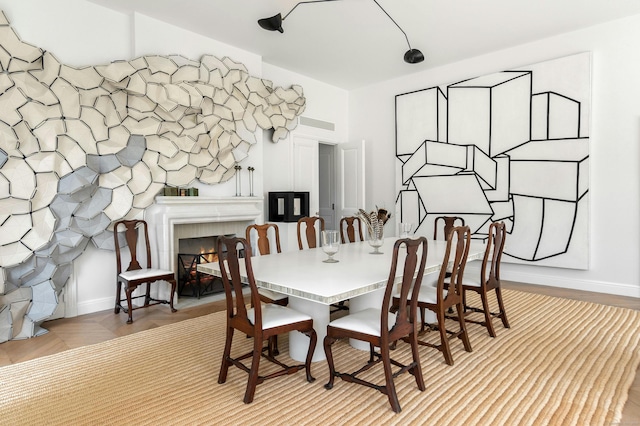 dining area featuring a tiled fireplace