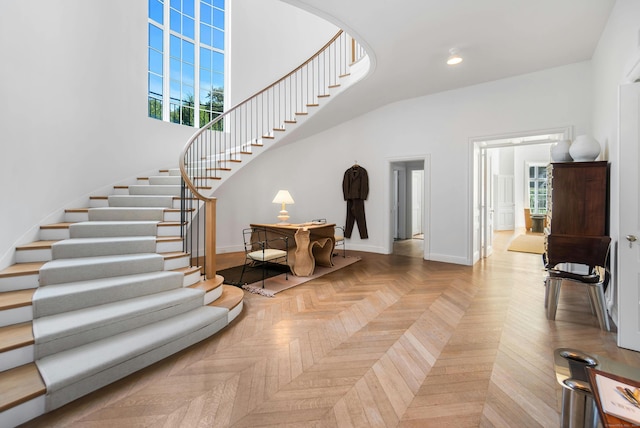 foyer with plenty of natural light and light parquet flooring