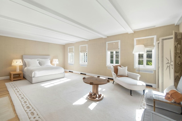 bedroom featuring multiple windows, beamed ceiling, and radiator heating unit