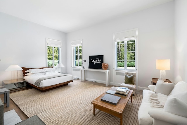 bedroom featuring hardwood / wood-style floors and multiple windows