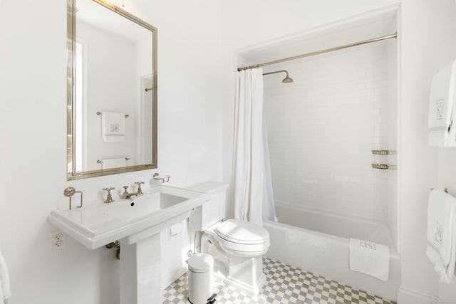 bathroom with shower / tub combo and toilet