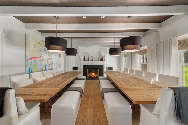 dining space featuring wood-type flooring and beamed ceiling