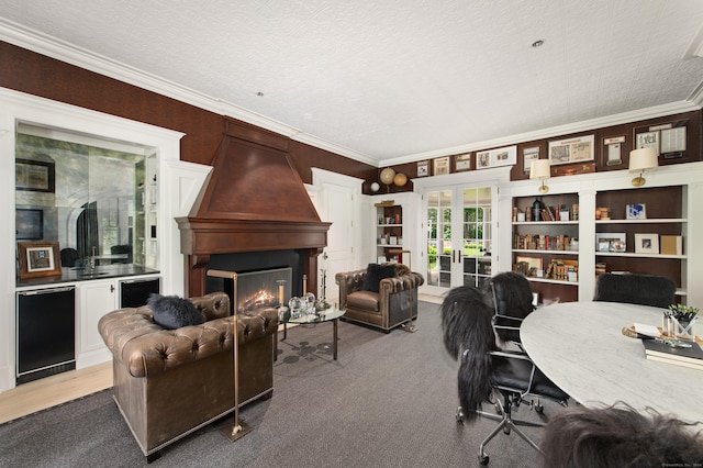 9 Cowdray Park Dr, Greenwich, CT 06831 - carpeted living area with french doors, ornamental molding, and a large fireplace